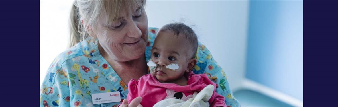 Paediatric nurse holding baby